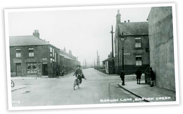 This view taken at Barugh Green cross-roads looking down towards Low Barugh shows the Spencers Arms public house. The shop on the left hand side is advertising Fry's chocolates in its window.