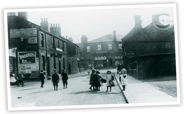 This view looking along High Street, Hoyland shows the old Post Office building. The increase in motor traffic means that the area is now subject to a one-way system. The older buildings on the left hand side of the photo have been replaced.